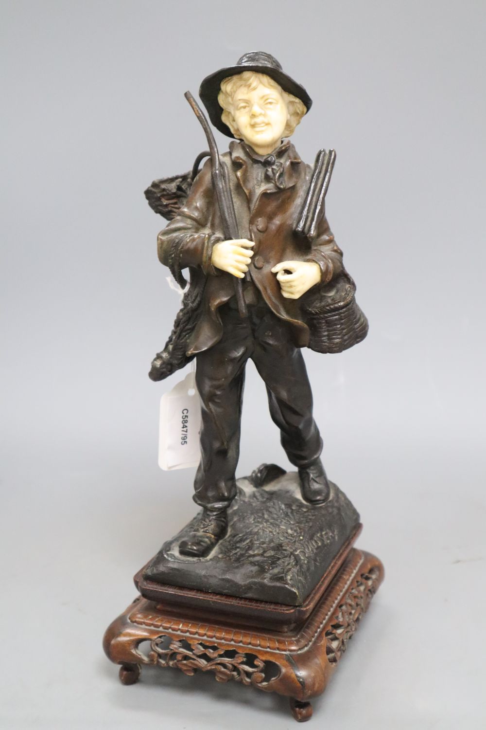 Rousseau. A bronze and ivory figure of a fisherboy, signed, height 26cm